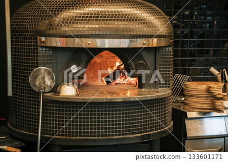 Traditional Italian Wood-Fired Pizza Oven with Flames 133601171