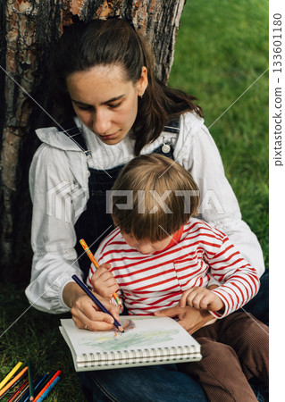 Mother and Toddler Drawing Together in a Summer Park. Parenting and Childhood Development Concept 133601180
