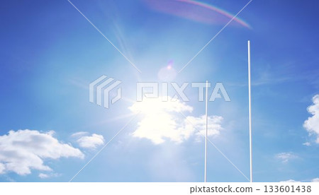 Two white goal posts are rising into flat design sky with sun lens flare behind cloud 133601438