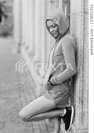 Thoughtful woman leaning on wall 133601451