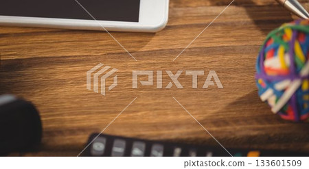 Mobile phone with rubber band ball on table 133601509