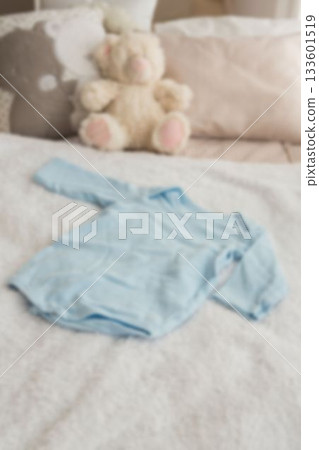 High angle view of clothing by stuffed toy on bed 133601519