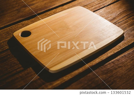 Wooden chopping board on hardwood flooring Wooden chopping board on hardwood flooring 133601532
