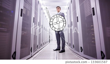 Flat design showing suited man guarding servers in data center aisle with shield and sword overlays 133601587
