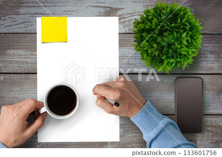Man drinking coffee on a piece of paper Man drinking coffee on a piece of paper 133601756