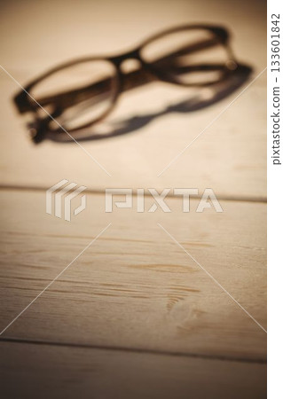 Black eyeglasses kept on table Black eyeglasses kept on table 133601842