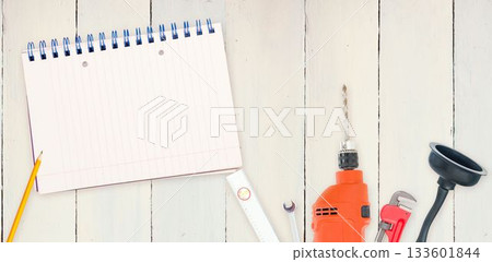 Tools and notepad on wooden background 133601844