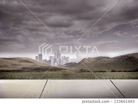 Cityscape in distance under cloudy sky Cityscape in distance under cloudy sky 133601893