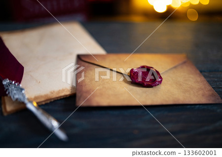 Blank Brown Paper Page on Black Wood Table with Christmas Decoration. Mock Up of Letter to Santa Claus. Top View of Jolly Father Desk with Envelopes, Xmas Ornament. View from Above. Blank Brown Paper Page on Black Wood Table with Christmas Decoration. Mock Up of Letter to Santa Claus. Top View of Jolly Father Desk with Envelopes, Xmas Ornament. View from Above. 133602001