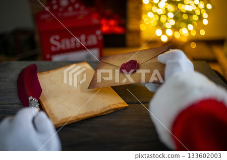 Close up of Santa Claus hands writing letter on Worden desk with copy space 133602003