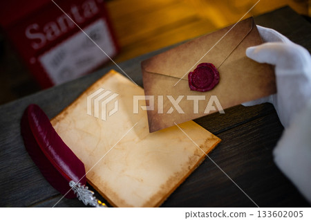 Close up of Santa Claus hands writing letter on Worden desk with copy space 133602005