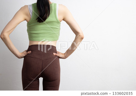 Rear view of a woman wearing sportswear with a toned waist and hips Rear view of a woman wearing sportswear with a toned waist and hips 133602035