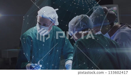 3 surgeons in green scrubs performing surgery in operating room, with scalpel and network overlay 3 surgeons in green scrubs performing surgery in operating room, with scalpel and network overlay 133602417