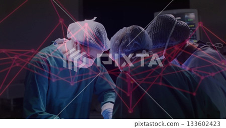 Surgical team using instruments in green scrubs in theatre, with monitor and red network overlay Surgical team using instruments in green scrubs in theatre, with monitor and red network overlay 133602423