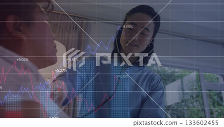 Offering father comfort, daughter in blue shirt with wireless earphones behind sofa in living room Offering father comfort, daughter in blue shirt with wireless earphones behind sofa in living room 133602455