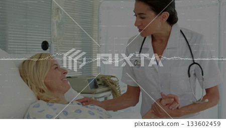 Holding senior patient's hand, nurse comforting patient in hospital bed, with stethoscope 133602459