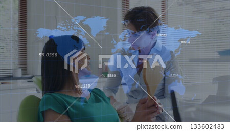 Dentist in lab coat inspecting patient's mouth at dental clinic, with mirror and world map overlay 133602483