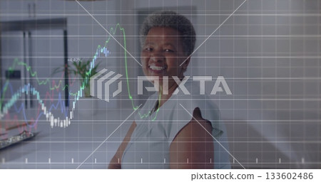Woman tracking multicolored line chart overlay in home office with laptop and plant, copy space 133602486