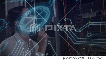 IT engineer analyzing overlays and inspecting racks with patch cables in data center, copy space 133602525