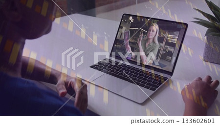 Client viewing consultant explaining tarot cards on laptop at home desk wearing headphones Client viewing consultant explaining tarot cards on laptop at home desk wearing headphones 133602601