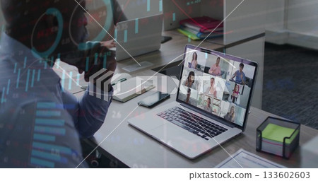 Talking African American man holding smartphone checking laptop online meeting at desk with binders Talking African American man holding smartphone checking laptop online meeting at desk with binders 133602603