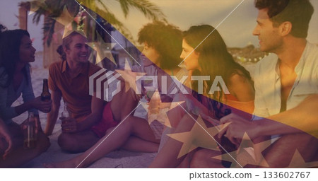 Sitting friends holding beer under string lights on palm lined beach with stars and stripes overlay Sitting friends holding beer under string lights on palm lined beach with stars and stripes overlay 133602767