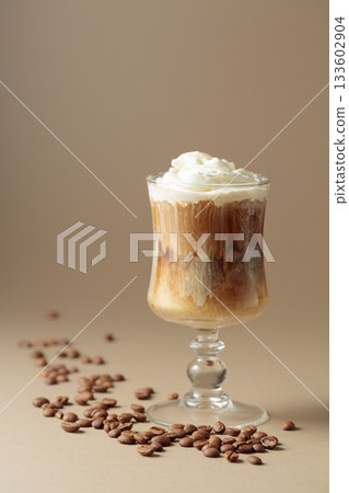 Cream and coffee cocktail on beige background. Cream and coffee cocktail on beige background. 133602904