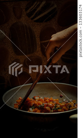 Hand stirring stir-fried vegetable cubes with a spatula, candid daily life home cooking scene Hand stirring stir-fried vegetable cubes with a spatula, candid daily life home cooking scene 133603174