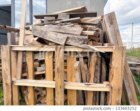 a large pile of wooden construction waste at a construction site 133603252