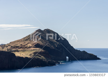 Close view of Sao Lourenco sea arch in cliffside with calm Atlantic stretching below Close view of Sao Lourenco sea arch in cliffside with calm Atlantic stretching below 133603317