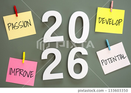 4 post-it paper clip on a green board with number 2026 in the middle and word passion, develop, improve, potential around. new year goal target concept 133603350