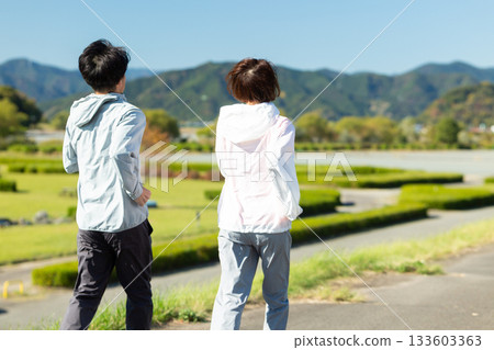 A middle-aged couple running outdoors A middle-aged couple running outdoors 133603363