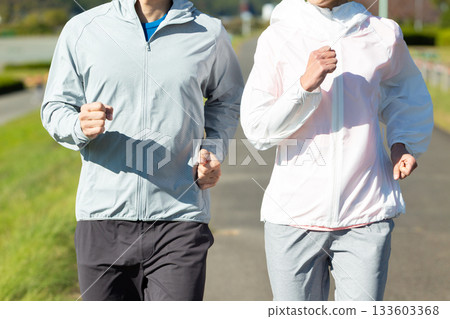 A middle-aged couple running outdoors A middle-aged couple running outdoors 133603368