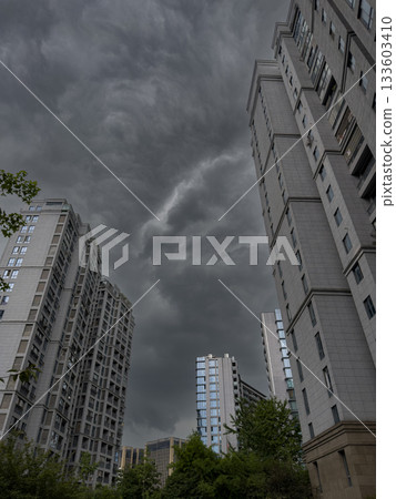 Tall residential buildings under a dramatic cloudy sky during daytime in China Tall residential buildings under a dramatic cloudy sky during daytime in China 133603410