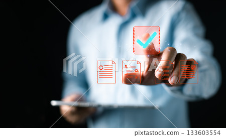A person interacts with a digital interface featuring floating icons of documents, charts, and a large checkmark, symbolizing document, digital, approve processes in a modern paperless workflow. A person interacts with a digital interface featuring floating icons of documents, charts, and a large checkmark, symbolizing document, digital, approve processes in a modern paperless workflow. 133603554