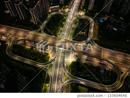 Aerial view of illuminated highway interchange with light trails at night in city of Hangzhou, China Aerial view of illuminated highway interchange with light trails at night in city of Hangzhou, China 133604648