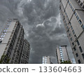 Tall residential buildings under a dramatic cloudy sky during daytime in China 133604663