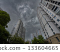 Tall residential buildings under a dramatic cloudy sky during daytime in China 133604665