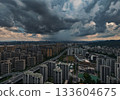 Aerial view of dark storm clouds looming over the cityscape of Hangzhou. 133604675