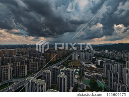Aerial view of dark storm clouds looming over the cityscape of Hangzhou. 133604675