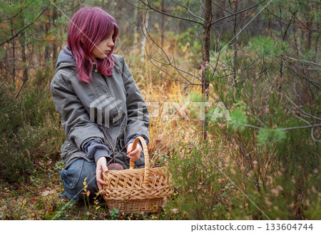 Young girl mushroom picking in autumn forest Young girl mushroom picking in autumn forest 133604744