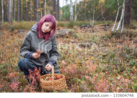 Girl foraging wild mushrooms in autumn forest 133604746