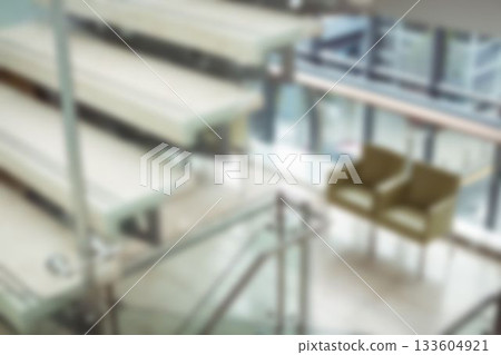 Chairs near staircase in office building 133604921