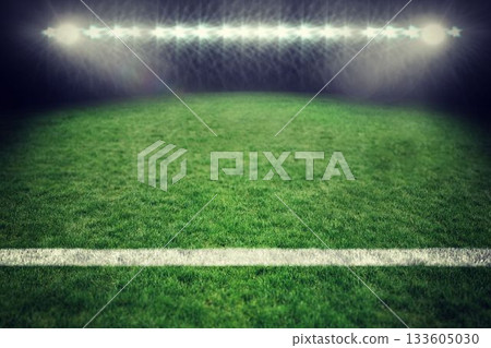 Grass sports field is glowing under stadium floodlights in flat design, showing white boundary line Grass sports field is glowing under stadium floodlights in flat design, showing white boundary line 133605030