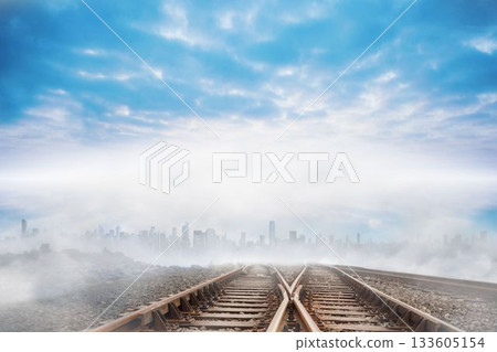 Train tracks leading to city on the horizon 133605154