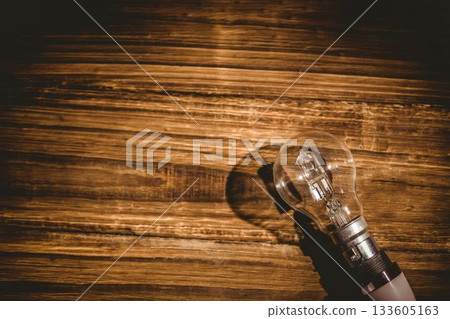 Light bulb on wooden table 133605163