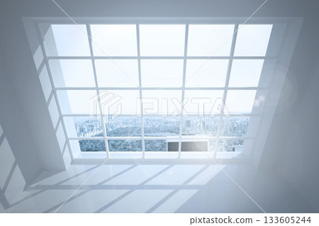 Room with large windows showing city 133605244
