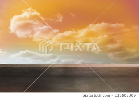 Flat design scene is showing grey paved surface meeting reflective horizon under warm tinted clouds 133605309