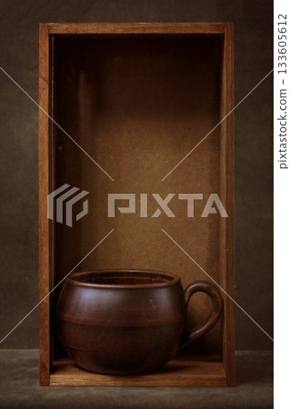 Still life with a cup of tea in a wooden box 133605612