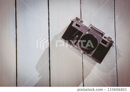 Old school camera on wooden floor Old school camera on wooden floor 133606801